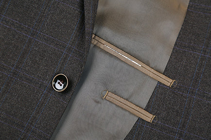 Brown 100% Wool Regular Fit 2 Button Glen Plaid blazer, showing checkered pattern, collar, buttons, pocket, and a tie.