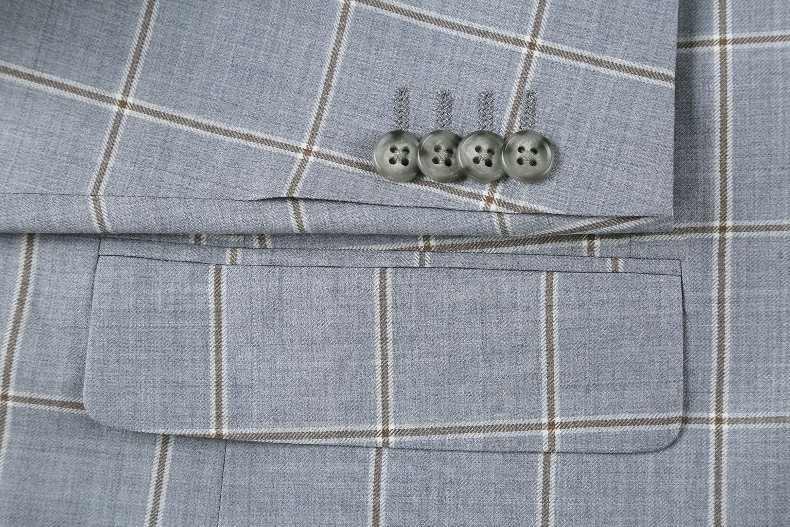 Close-up of a button on the Stone Blue 100% Wool Windowpane Pattern Regular Fit 2 Button Blazer.