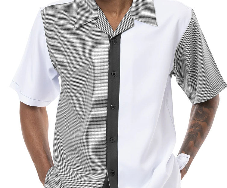 Close-up of the black houndstooth short sleeve walking suit top, showing sleeve, collar, button, and pocket.