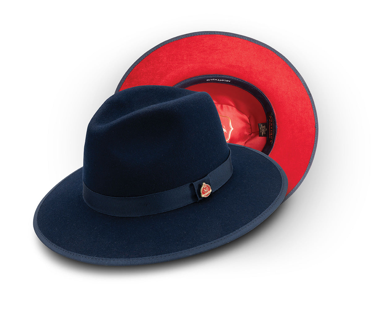 Solid navy wool felt hat with 3 ¼ inch brim and red bottom.