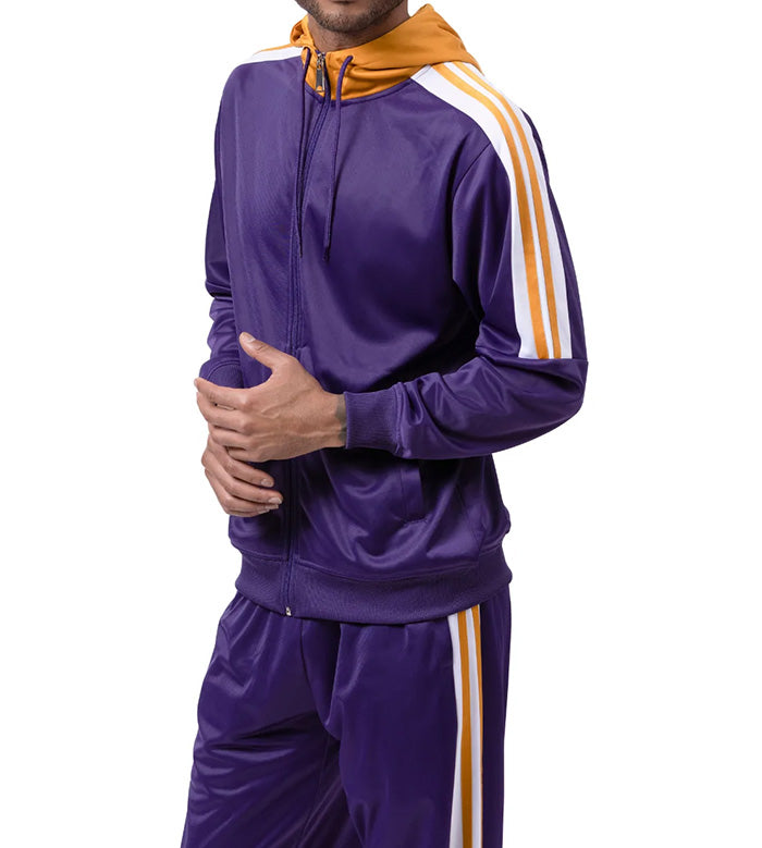 Person wearing a purple tracksuit with orange and white stripes on a white background
