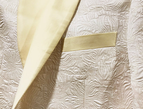Close-up of solid Ivory fabric for Slim Fit Tuxedo 4 Piece with Satin Shawl Collar Beveled Designed Vest.