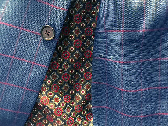 Detailed close-up of the checkered blue fabric for the Slim Fit Blue Blazer, also showing a tie.