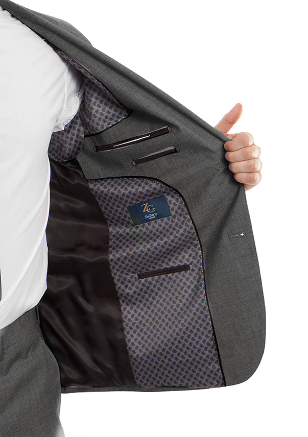 Full shot navy blue Super 150s wool pinstripe suit with two-button jacket, white shirt, red tie.