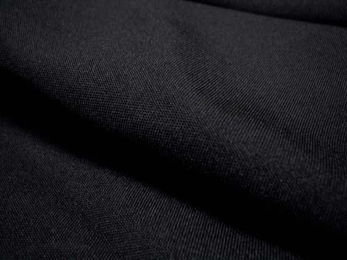 Detailed close-up of solid black fabric for Men's Regular Fit Tuxedo 2 Piece Collection, 3 button design.