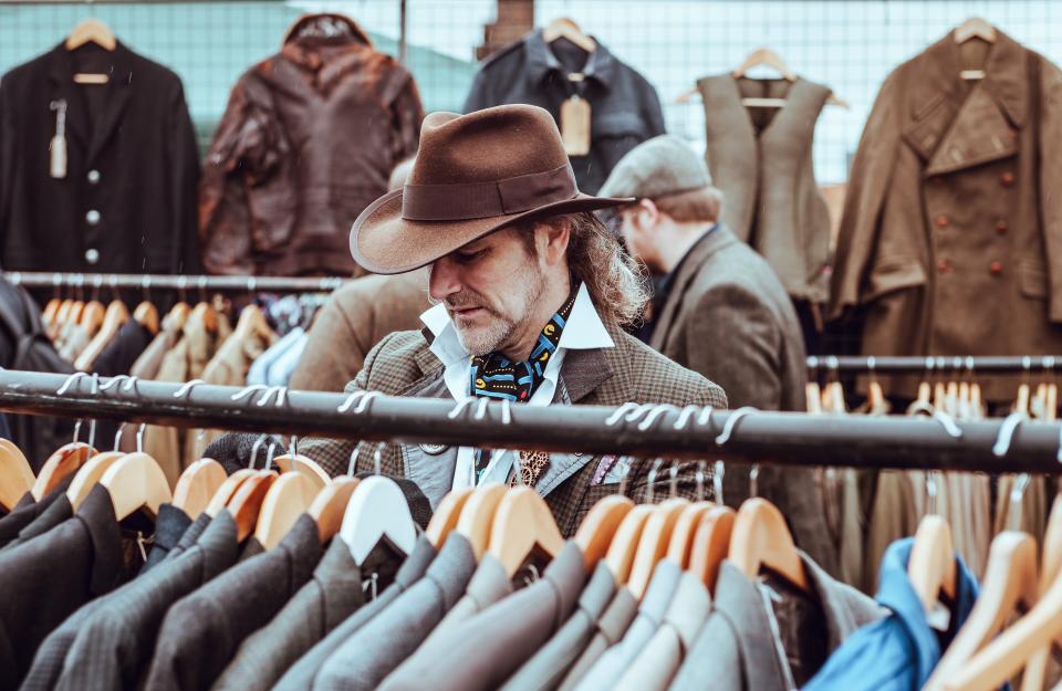 a man searching for suits or tuxedo in store