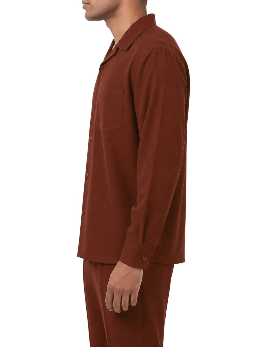 Man wearing a maroon shirt and pants on a white background