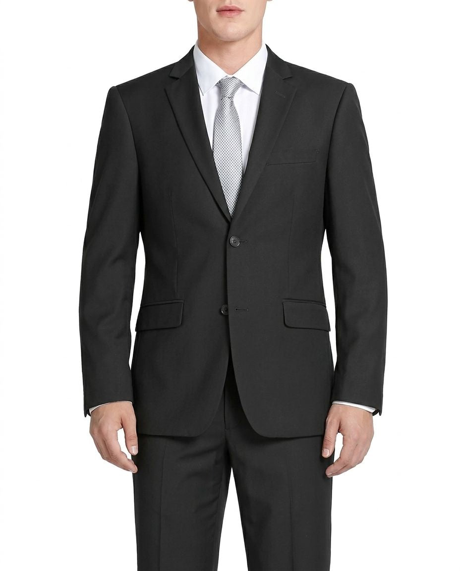 A man wearing a black two-piece suit with a white dress shirt and a light gray patterned tie, shown from the neck down against a plain white background.