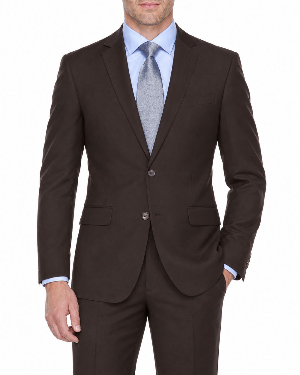 A man wearing a dark brown two-button suit jacket with matching trousers, styled with a light blue dress shirt and a light gray tie, against a plain white background.