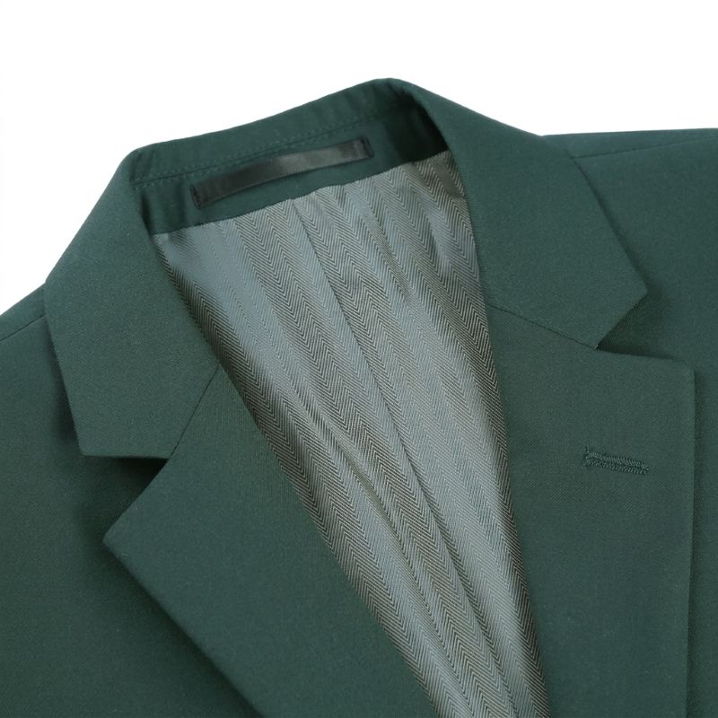 Close-up of a dark green tailored blazer jacket with a light gray patterned lining visible inside the collar, set against a plain white background.