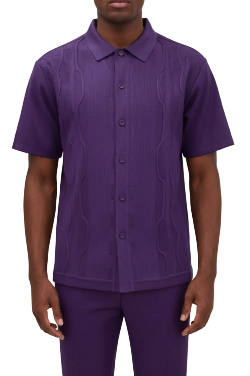Man wearing a purple patterned shirt and pants on a white background