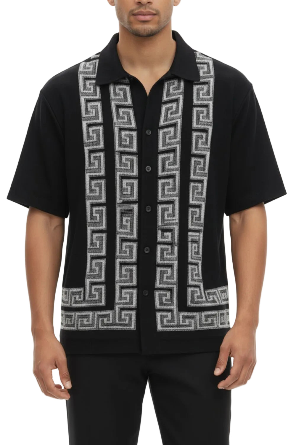 Man wearing a black shirt with a geometric pattern on a white background
