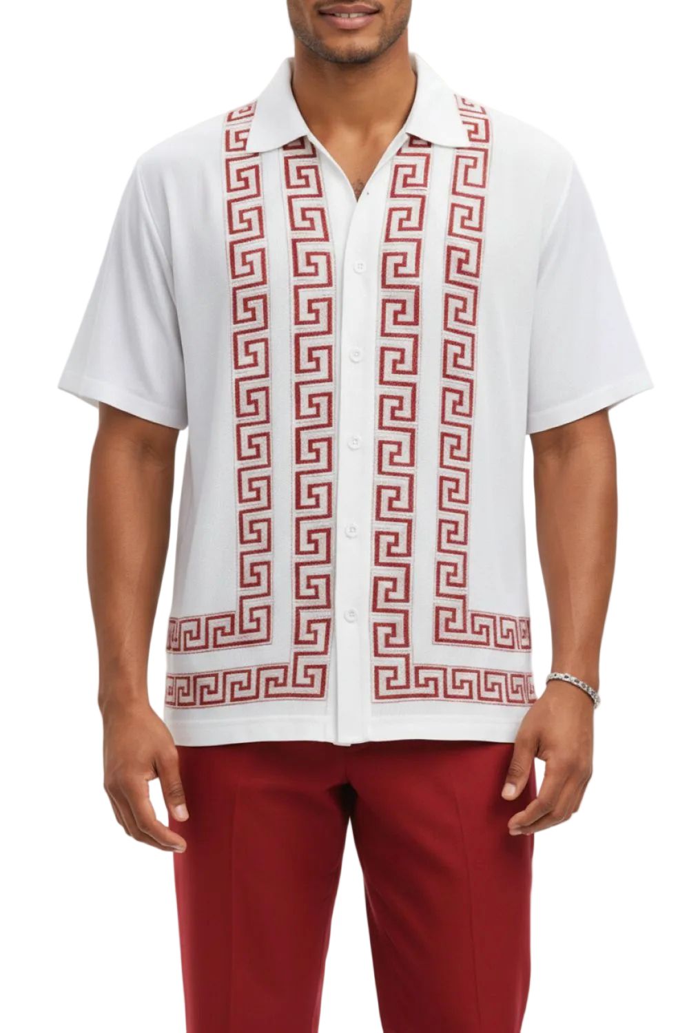 Man wearing a white shirt with red geometric pattern and red pants on a white background