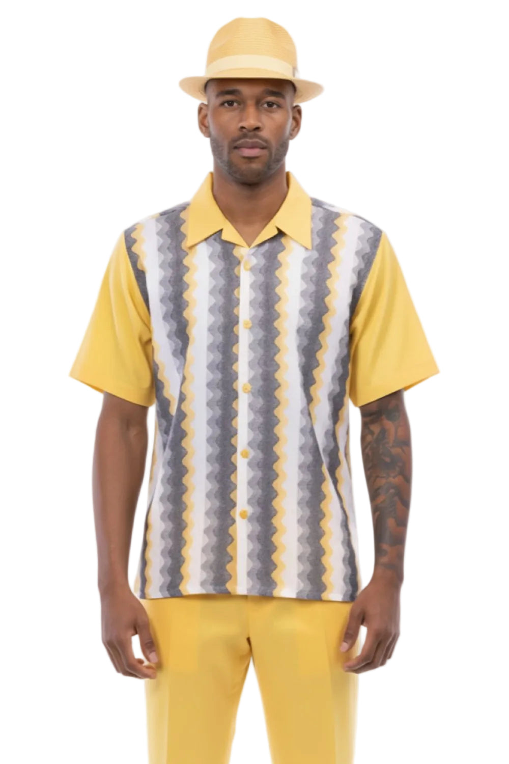 Man wearing a yellow and patterned shirt with a white background