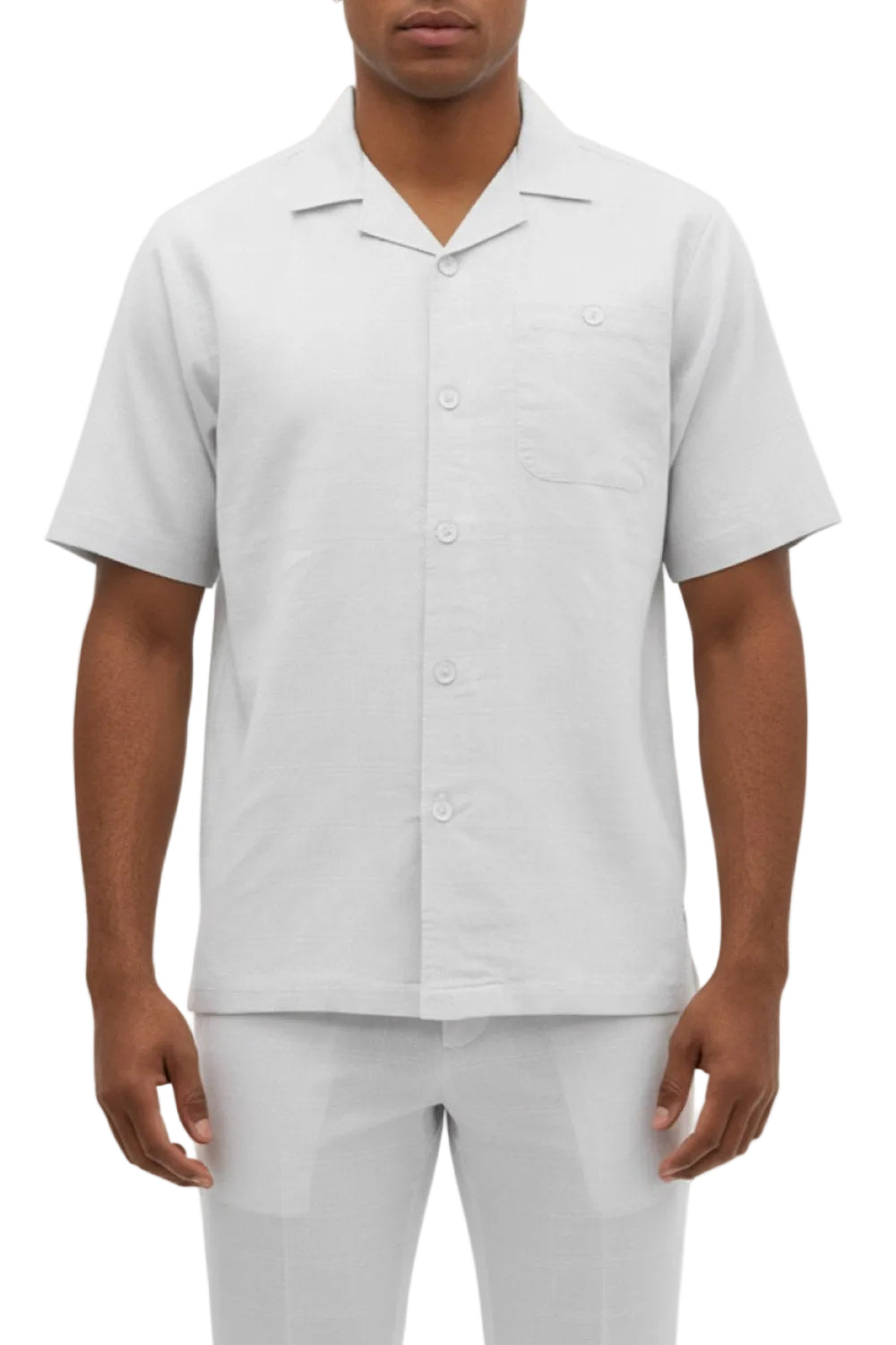 Man wearing a white short-sleeve shirt and pants on a white background