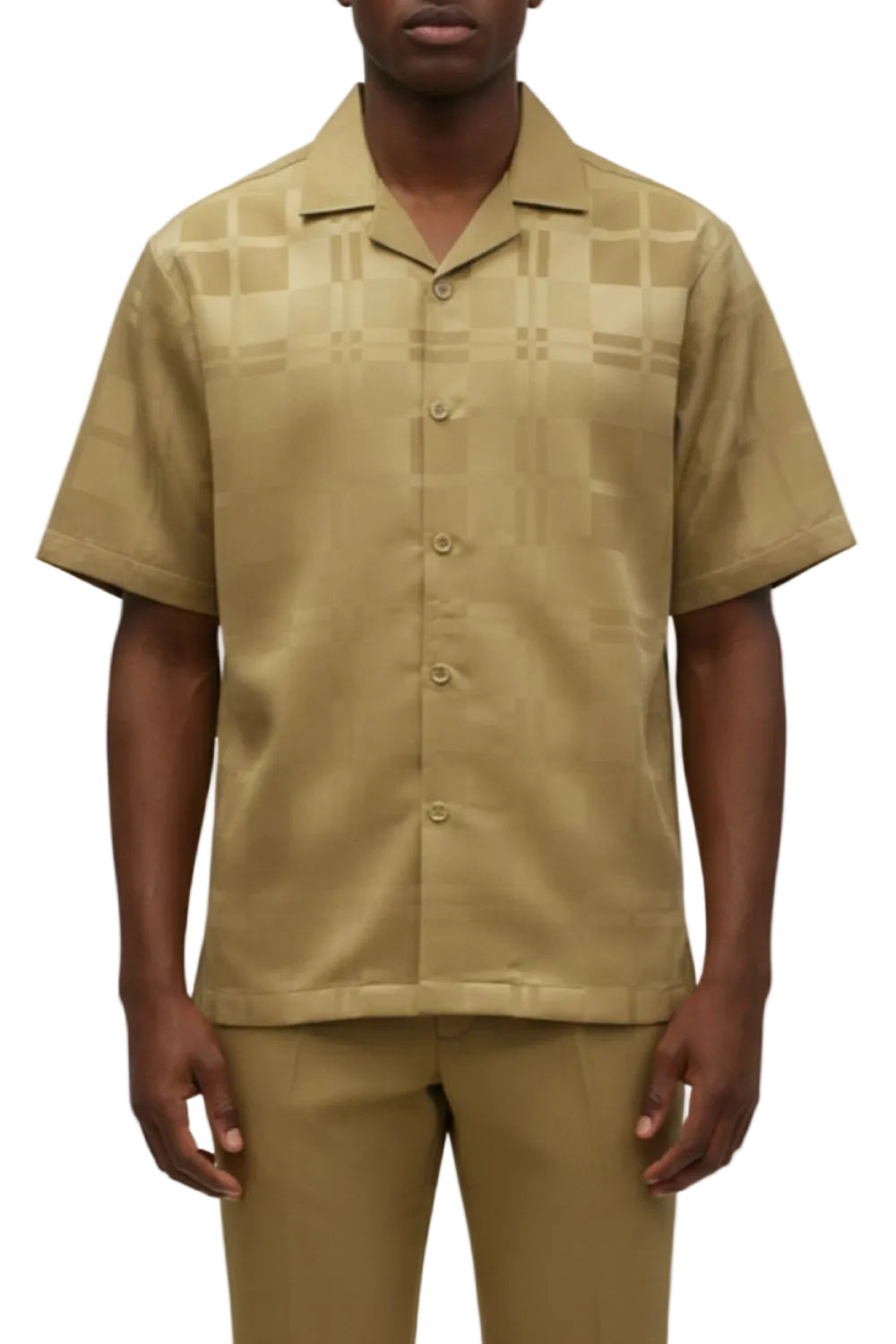 Man wearing a beige patterned shirt and pants on a white background