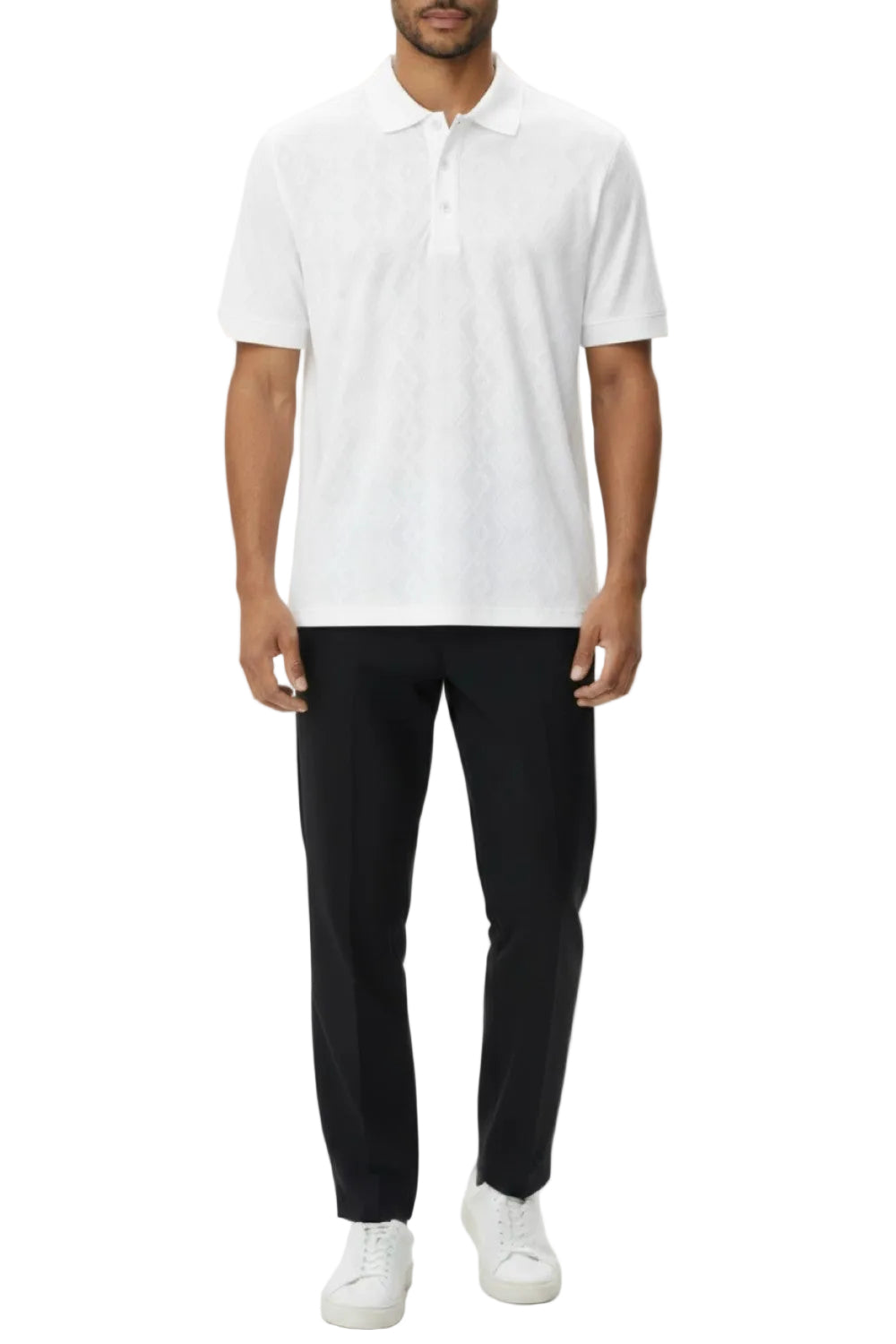 Man wearing a white polo shirt, black pants, and white sneakers on a white background
