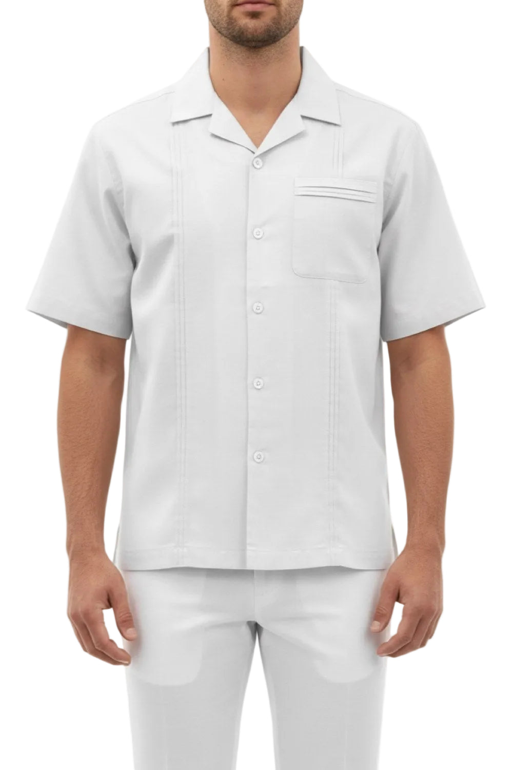 Man wearing a light gray short-sleeve shirt and pants on a white background