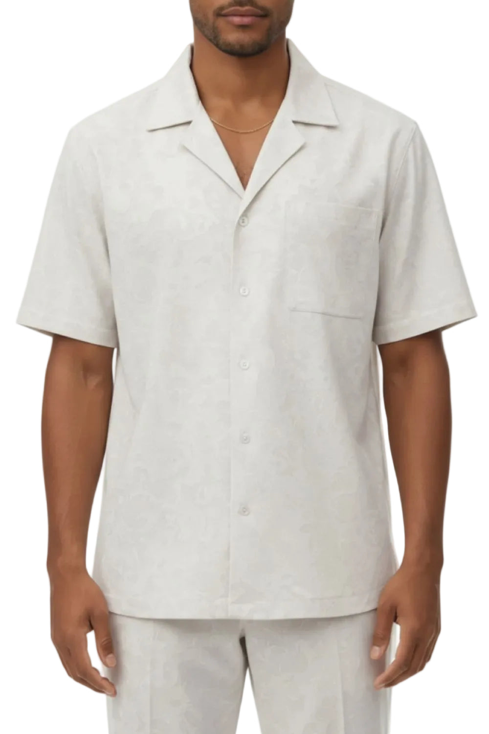 Man wearing a light white short-sleeve shirt with open collar on a white background