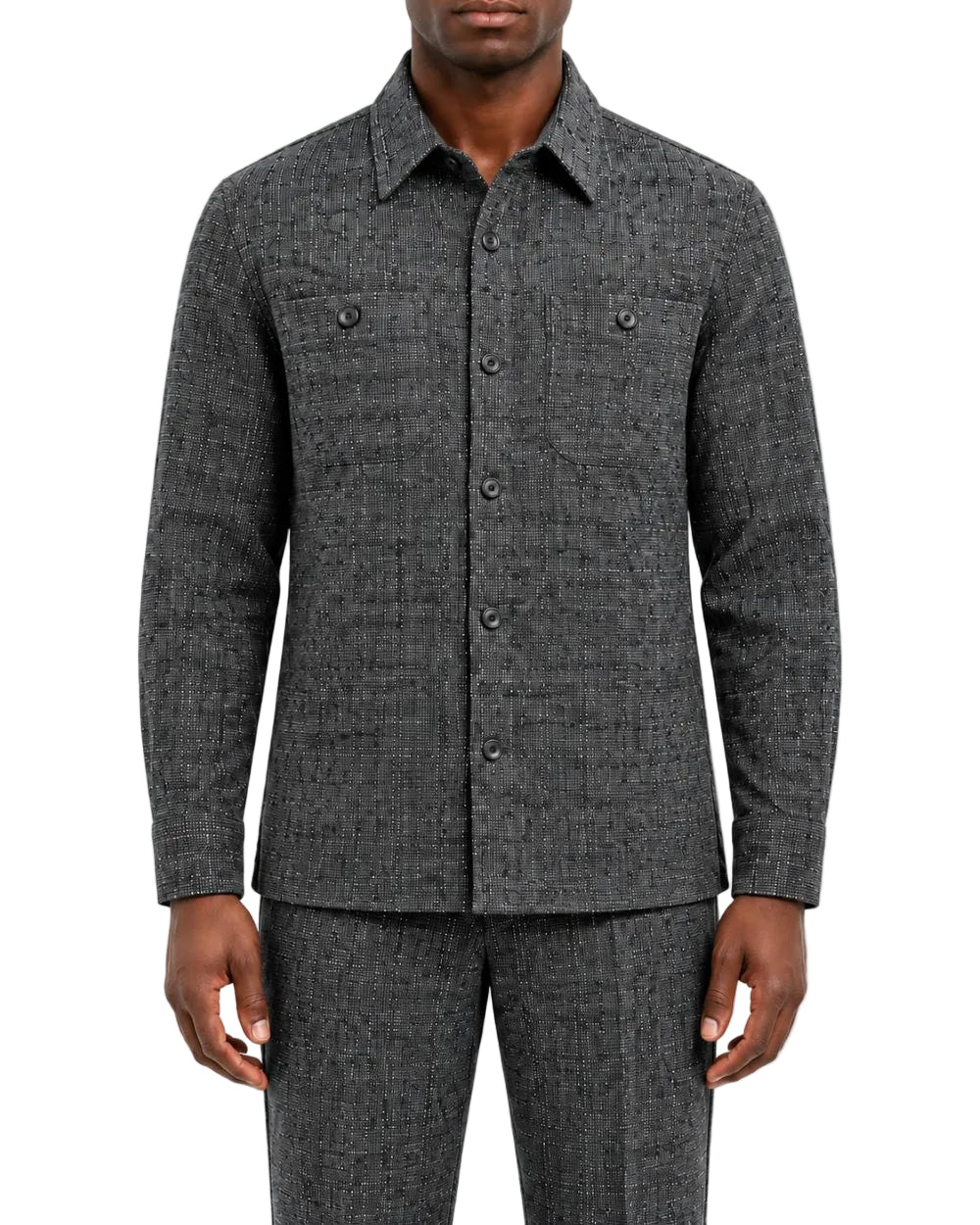 A man wearing a dark gray textured long-sleeve button-up shirt and matching gray trousers, shown from the chin down against a plain white studio background.