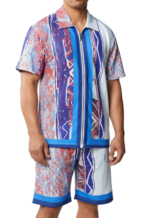 A man wearing a matching short-sleeve collared shirt and shorts set with a bold vertical stripe pattern in blue, purple, red, and white, photographed against a plain white background.