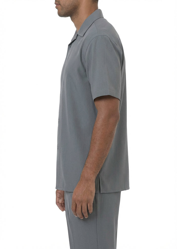 Close-up of the solid gray short sleeve, collar, and buttons of the walking suit top on a white background.