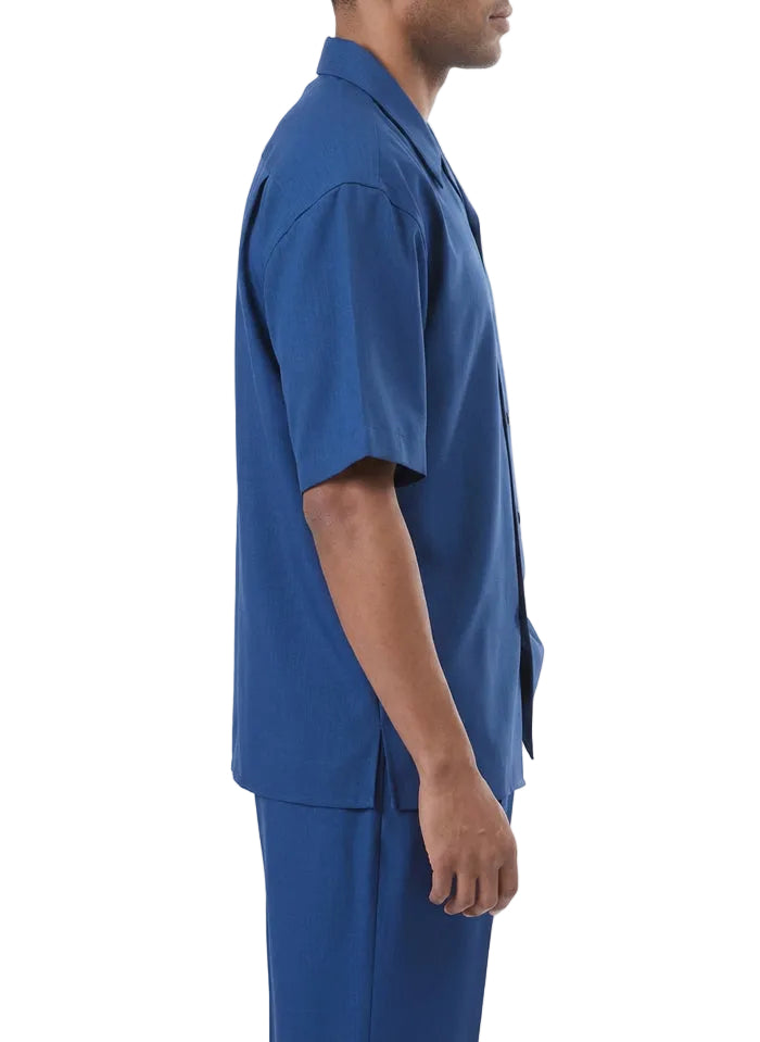 Solid sapphire short sleeve of a walking suit, showing button and pocket detail on white background.