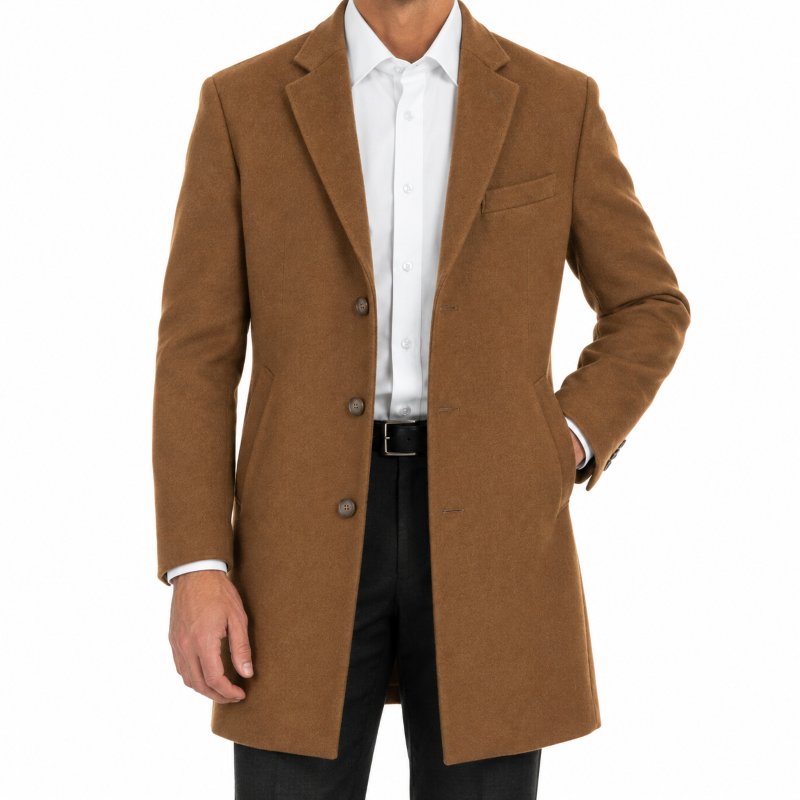 A man wearing a camel brown wool-blend overcoat over a white dress shirt and black trousers, photographed against a solid white background.