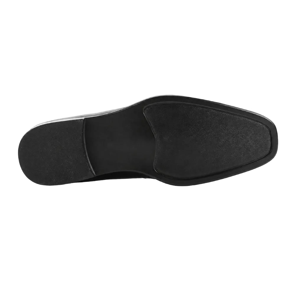 A black slip-on shoe shown from a top-down view, displaying its textured outsole and square toe against a plain white background.