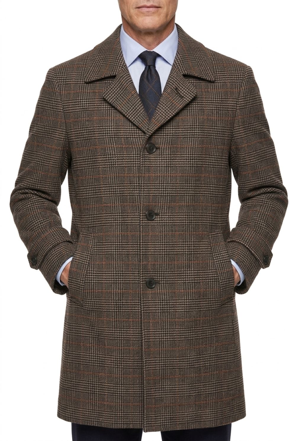 A man wearing a brown and beige plaid wool-blend overcoat, styled with a light blue dress shirt and a dark tie, shown from the waist up against a plain white background.