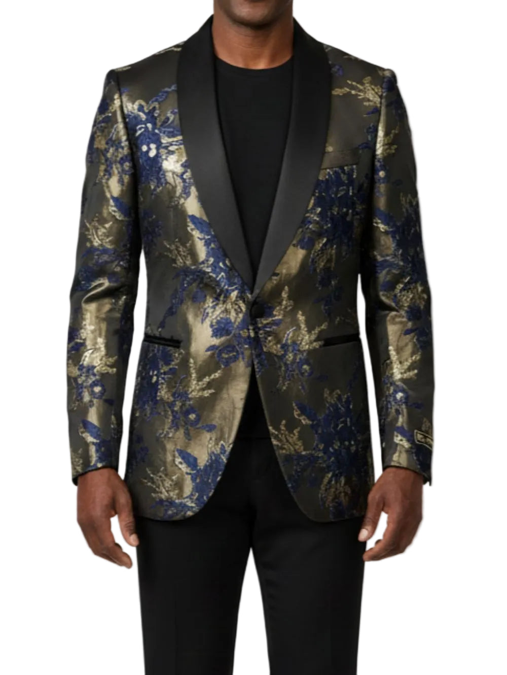 Man wearing a floral patterned blazer with black lapels on a plain background