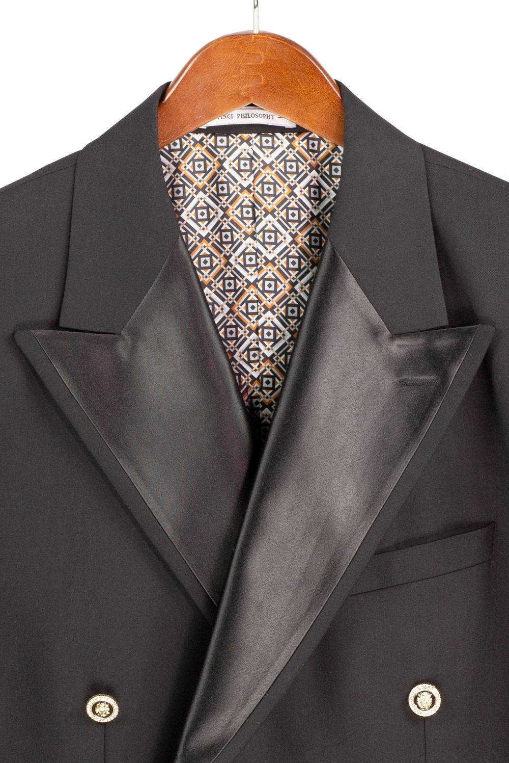 Gray suit jacket with a patterned tie on a hanger