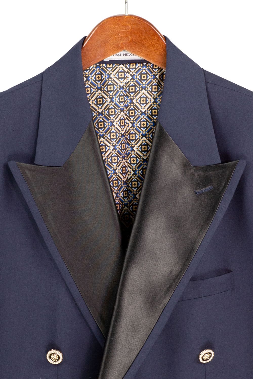 Navy blue suit jacket with a patterned tie on a hanger
