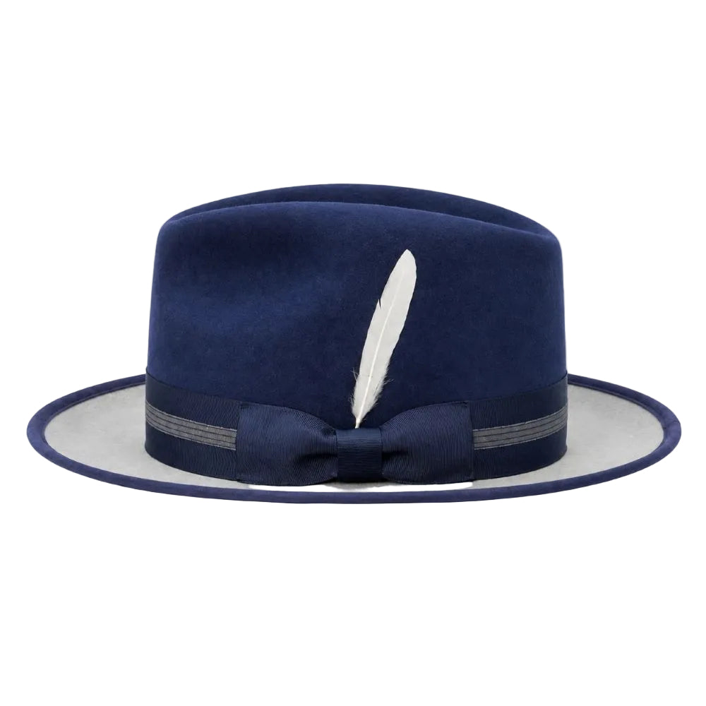 A navy blue felt fedora hat with a matching fabric bow on the brim, a white feather accent, and a light gray underside of the brim, shown against a plain white background.