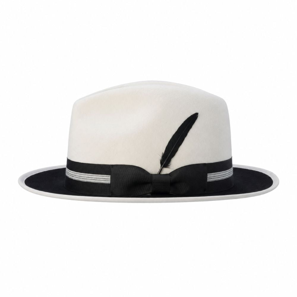 Side view of white and black two-tone wool felt fedora with ribbon band and feather