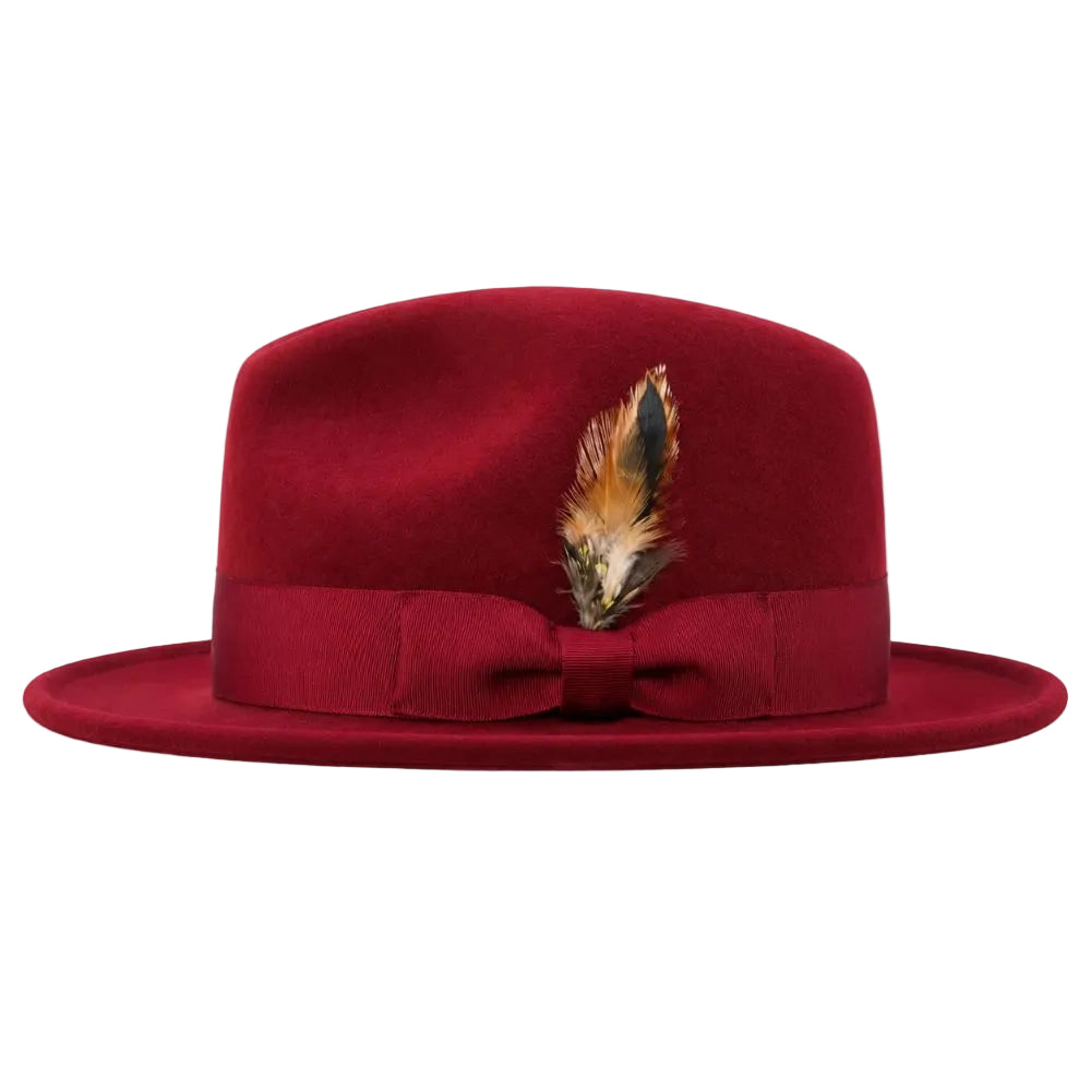 A deep red felt fedora hat with a matching red ribbon band and bow, decorated with a brown and black feather, shown against a plain white background.