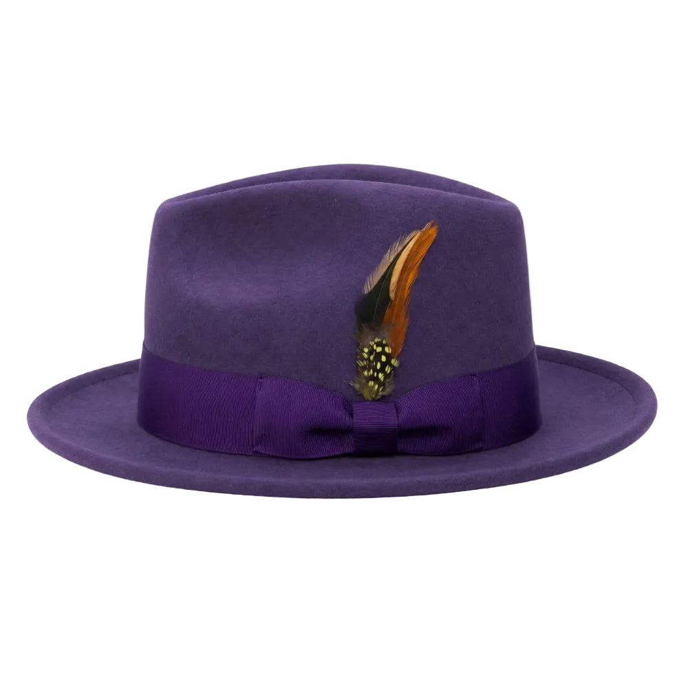 A purple felt fedora hat with a matching purple satin band and bow, decorated with a brown and black feather, shown against a plain white background.