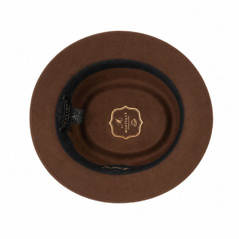 A top-down view of a brown felt hat with a black inner band and a gold shield-shaped logo in the center, displayed on a solid white background.
