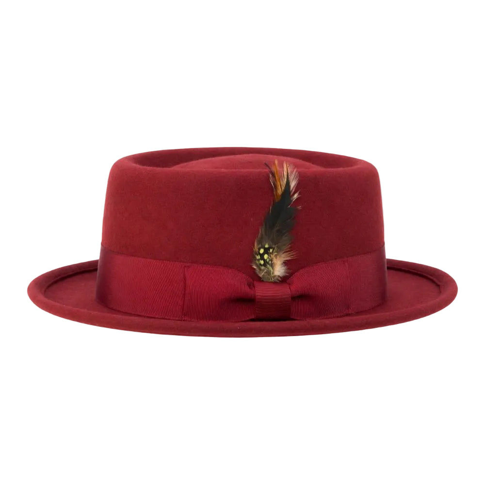 A deep red felt fedora hat with a matching red ribbon band and bow, decorated with a small feather accent, shown against a plain white background.