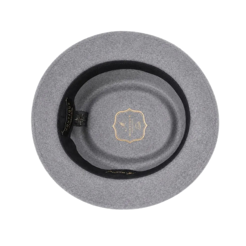 Top-down view of a gray felt hat with a black inner band and a gold crest logo in the center, set against a plain white background.