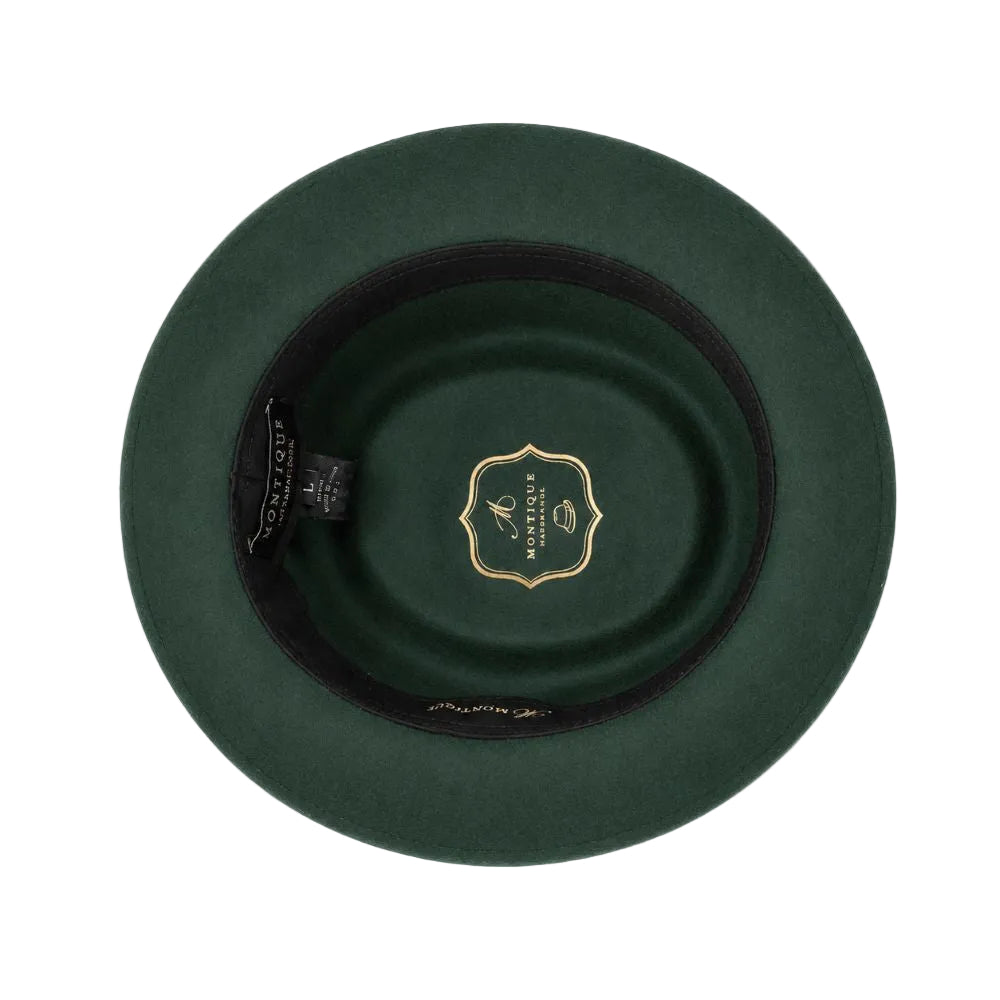 Top-down view of a dark green felt hat with a black inner band and a gold shield-shaped logo in the center