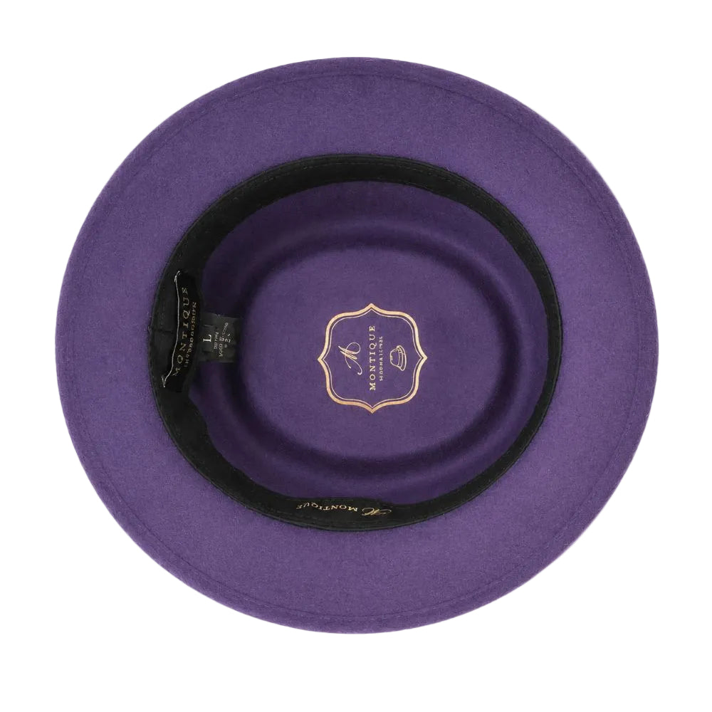 Top-down view of a purple felt hat with a black inner band and a gold logo patch in the center, set against a plain white background.