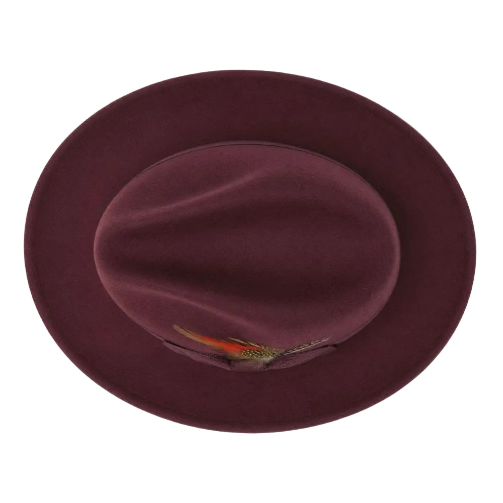 A top-down view of a dark burgundy felt fedora hat with a small orange and green feather accent on the brim, set against a plain white background.