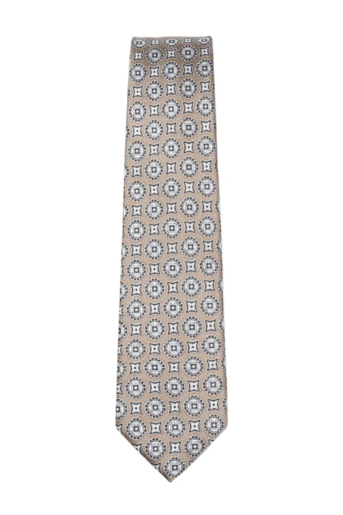 Beige tan tie with geometric medallion pattern laid flat