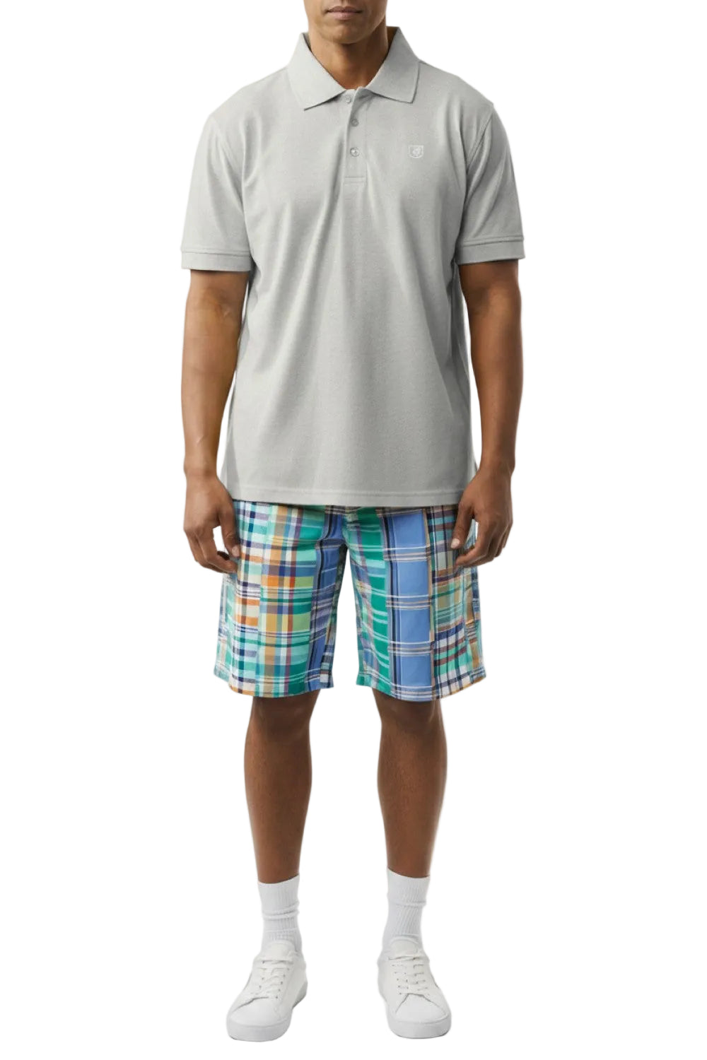 Person wearing a light gray polo shirt and plaid shorts on a white background
