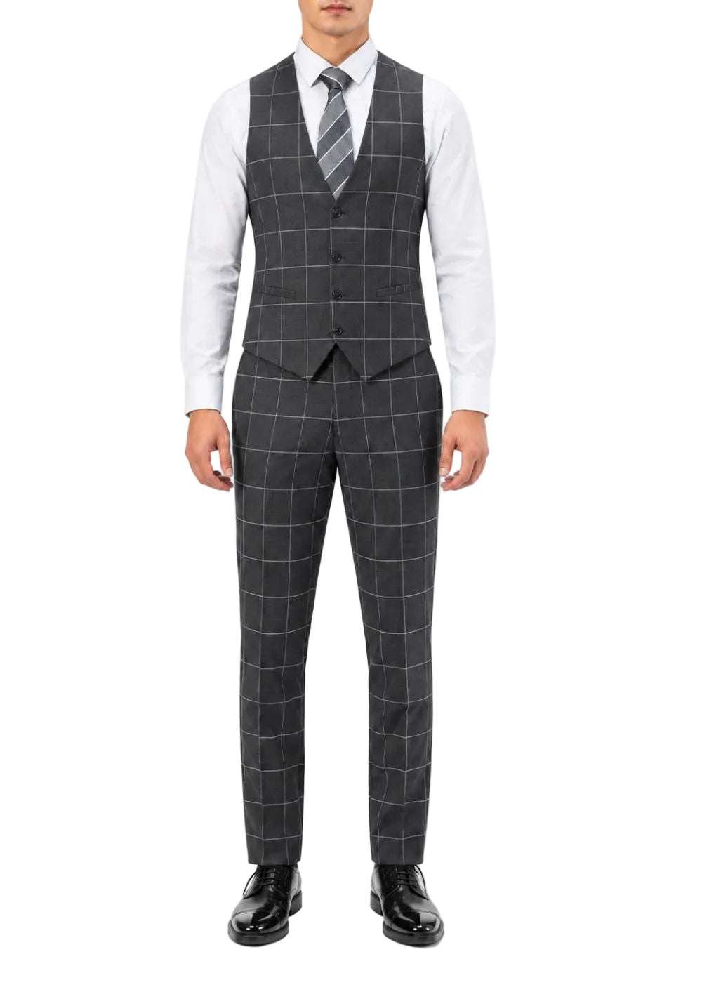 A man wearing a dark gray three-piece suit with a windowpane check pattern, consisting of a vest, matching trousers, and a matching striped tie, styled with a white dress shirt and black dress shoes.