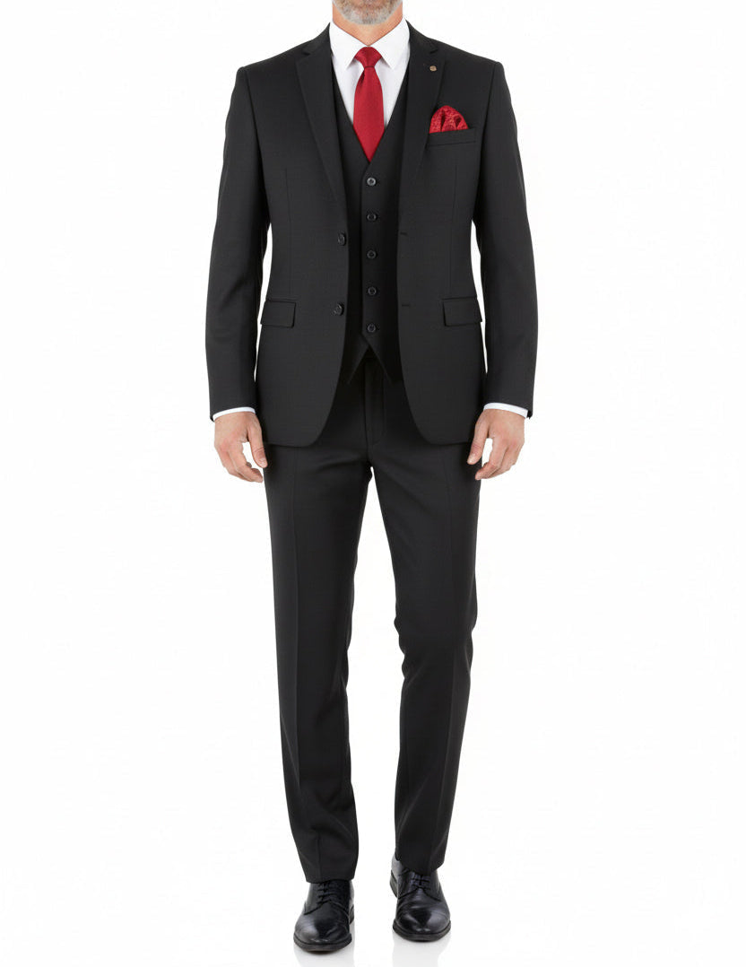 Man wearing a black suit with a red tie and pocket square on a white background