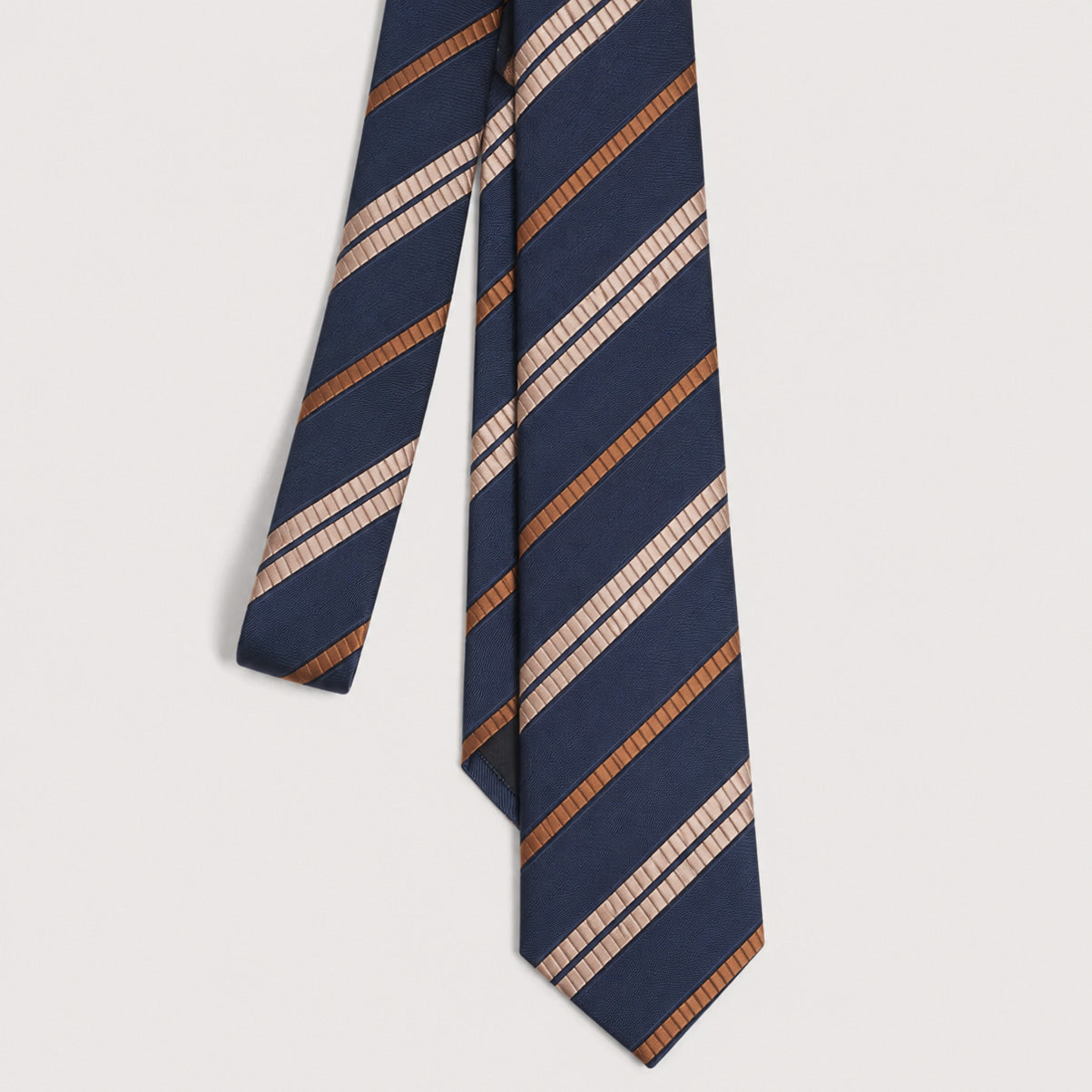 A navy blue necktie with diagonal stripes in textured tan, brown, and cream, displayed against a light gray background.
