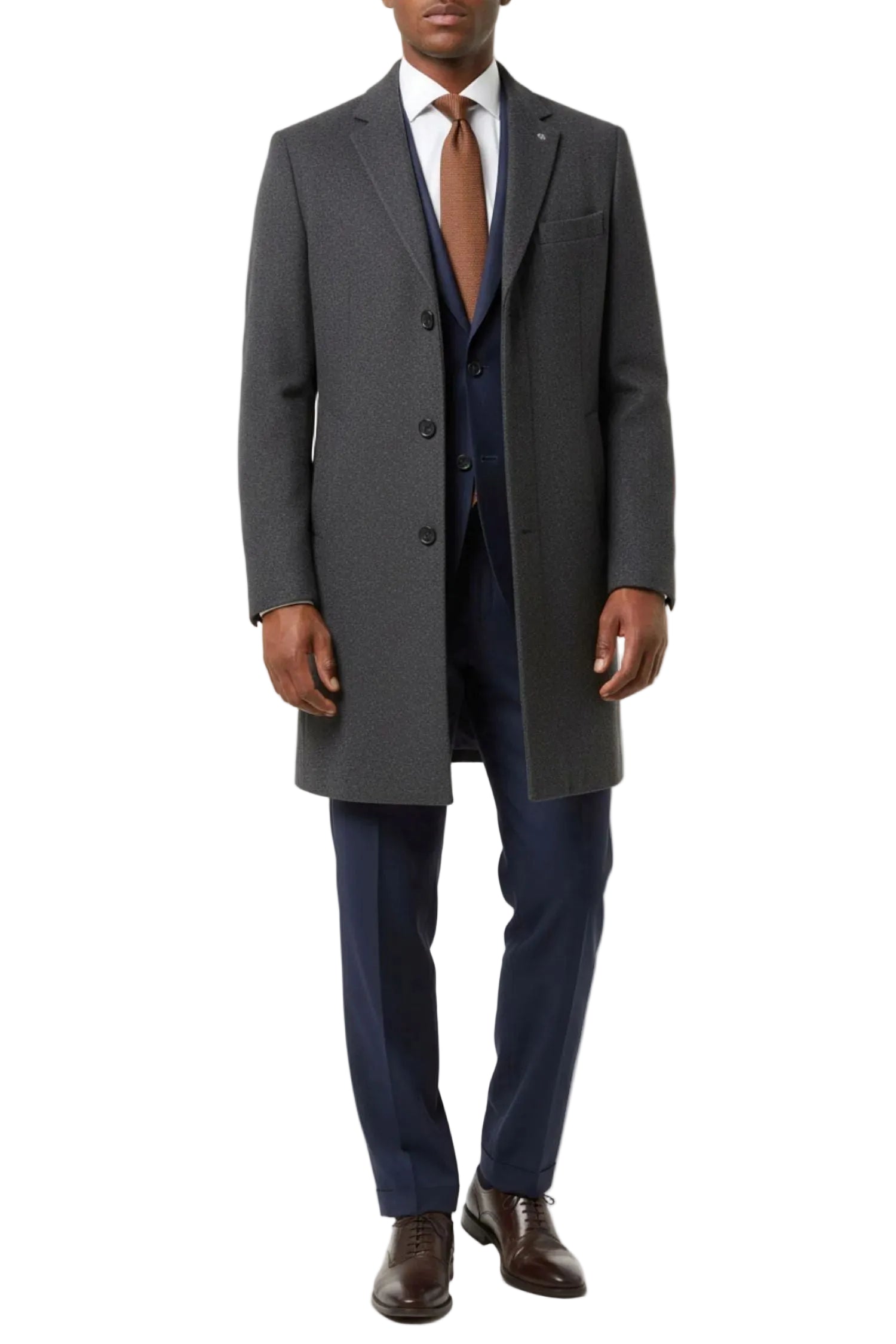 Man wearing a gray overcoat, white shirt, brown tie, and blue pants on a white background