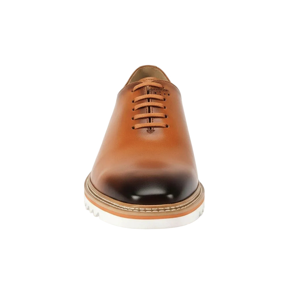 Tan leather dress shoe on a white background